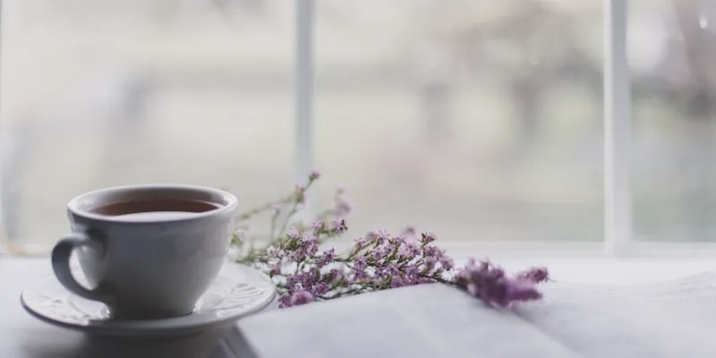 A pure white ceramic teacup on a white saucer