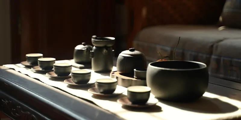 Tea cups arranged on a wooden table, like a royal pour
