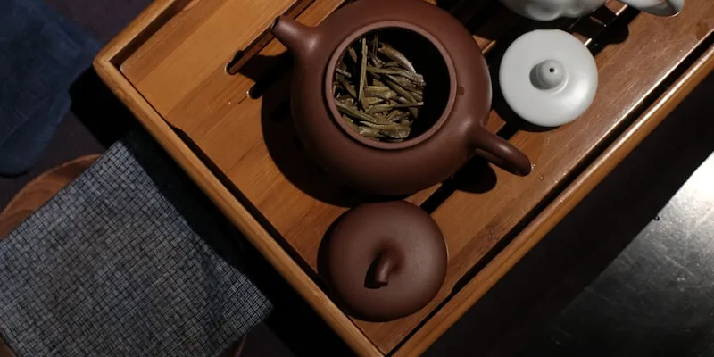 A gongfu tea set with teapot and cups on a wooden tray